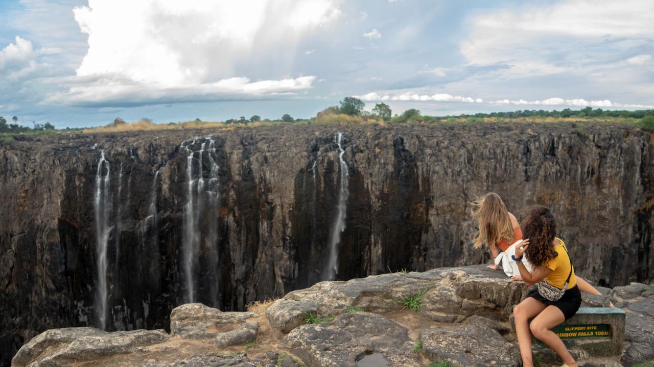 No smoke, no thunder ... tourists enjoy a serene time as they look on trickles of water at the Victoria Falls, on December 10, 2019. Photo: Zinyange Auntony/AFP