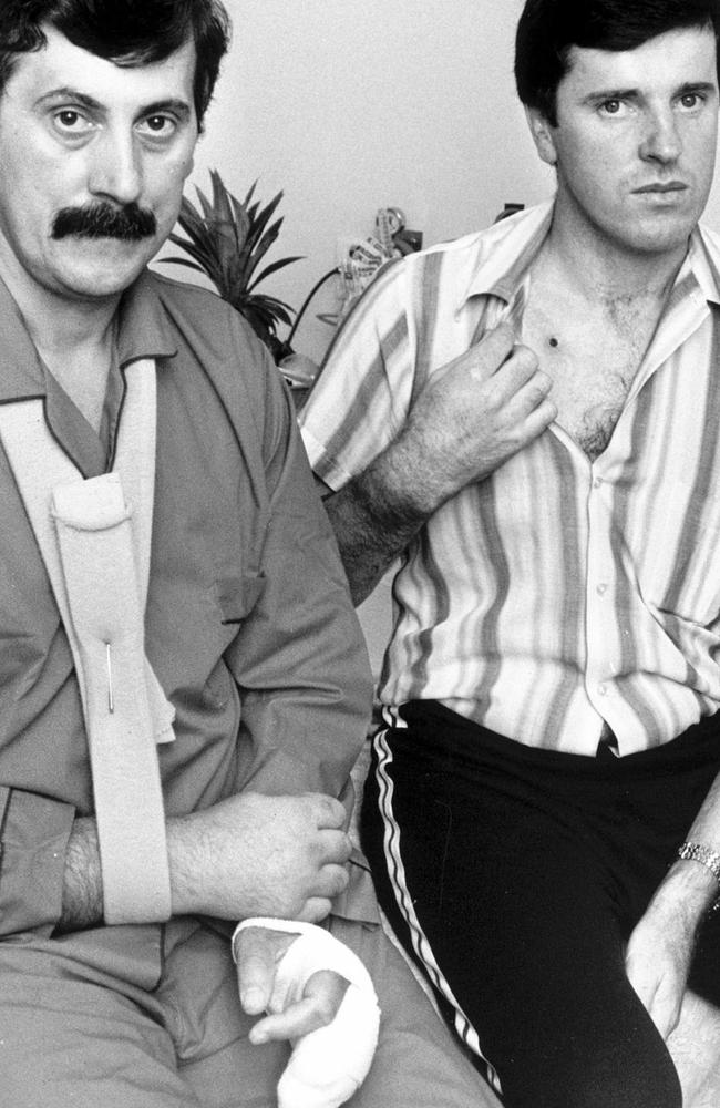 Det-Sgt John Kapetanovski (left) and Sgt Rod MacDonald (right) pictured soon after they were both shot and wounded during a 1986 gunbattle with Noble Park gunman Pavel “Mad Max” Marinof. Sgt MacDonald shot and killed Marinof after he and Det-Sgt Kapetanovski intercepted Marinof’s vehicle on the Hume Highway at Kalkallo.