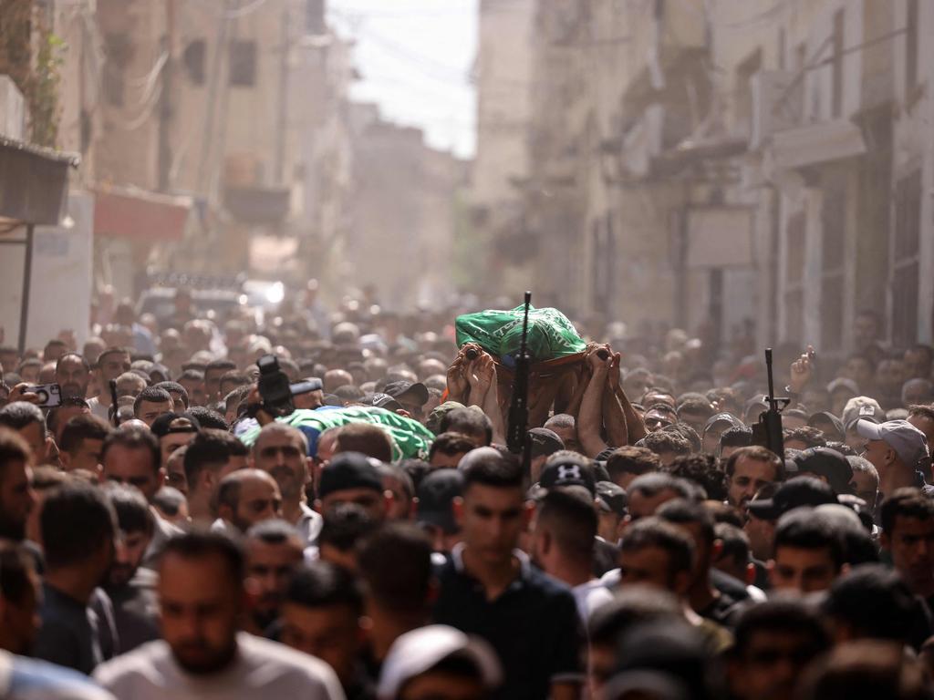 Mourners march through the streets after Palestinians were killed in an Israeli air strike in Jenin in the occupied West Bank.