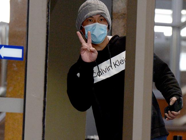 \Chee Kit Chong, 44, gives the peace sign to reporters. Picture: Andrew Henshaw