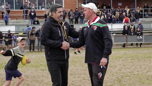 Pines coach Paddy Swayn (right) congratulates Frankston YCW coach Paul Goonan on Saturday. Picture: Valeriu Campan