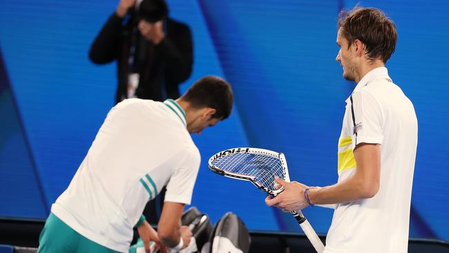 Daniil Medvedev (right) fetches a new racquet. Picture: Michael Klein