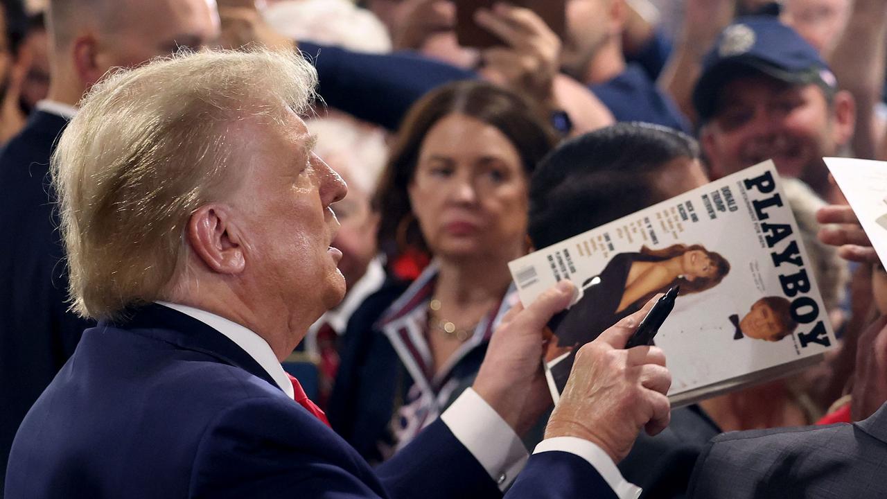 Donald Trump holds a copy of the March 1990 Playboy magazine where he appears on the cover. Picture: Scott Olson/Getty Images via AFP