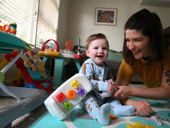 SYDNEY, AUSTRALIA - OCTOBER 21: Rosangela Thomas plays with her son Oscar (9 months) at their home on October 21, 2022 in Sydney, Australia. Treasurer Jim Chalmers will deliver the first Federal Budget for the Albanese Labor Government on October 25, 2022 - warning Australians to brace for spending cuts and limited cost-of-living relief. Focussing on rising inflation (6.1 per cent in the June Quarter) and a darkening world economy. The budget will include lower priced medicines, available from January 1, 2023, $1.4 billion to extend COVID-19 response measures until December 31st, $33.6 million in medical research grants to help reduce the number of those affected by heart disease and stroke. For families and women, paid parental leave allowance will be expanded by six weeks up to 26 weeks, amounting to an extra $6499 and $15.8 million will fund projects to increase womenÃ¢â¬â¢s participation and representation in the workforce and leadership roles. (Photo by Lisa Maree Williams/Getty Images)