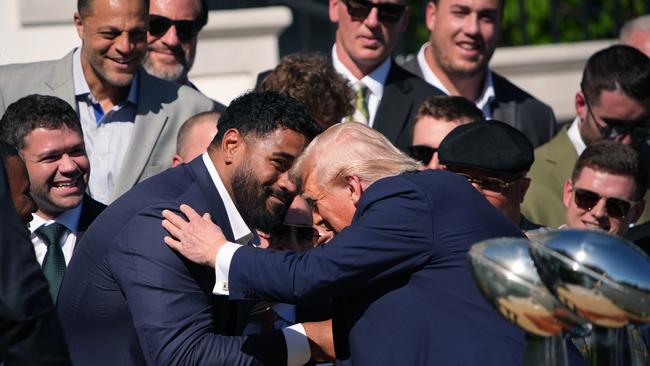 Donald Trump got up close and personal with Philadelphia Eagles offensive tackle, Australian Jordan Mailata, at the White House. Picture: Getty Images