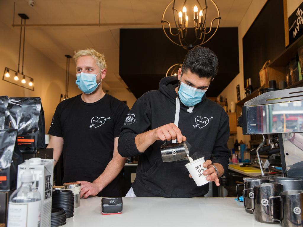 Adam Zeineddine (R), owner of Swan Street cafe My Oh My and barista Andy Balloch adopted the use of masks early. Picture: Paul Jeffers/The Australian