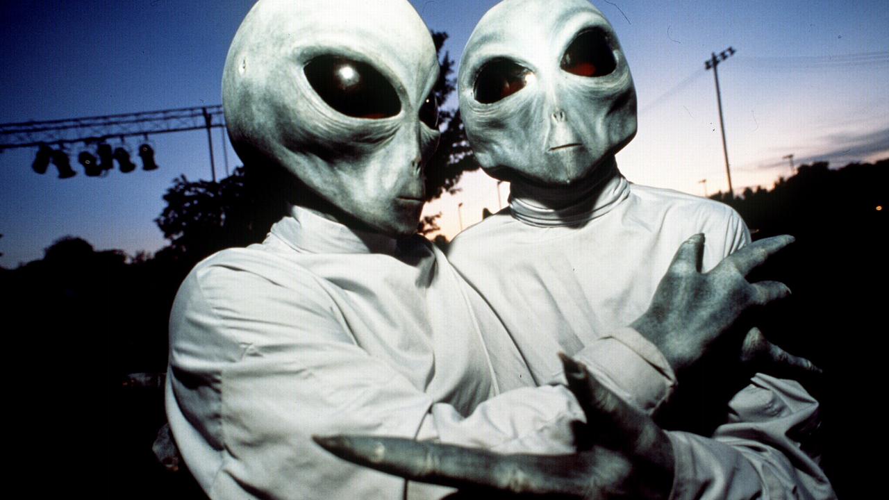 Two people dressed in alien costumes for 1996 UFO Festival in Roswell, New Mexico, US.