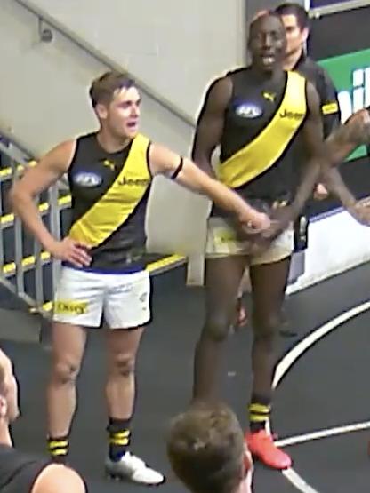 Jayden Short grabs Mabior Chol during the team song.