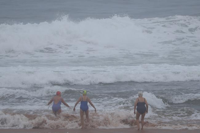 People braving the big surf on the northern beaches. Picture: John Grainger