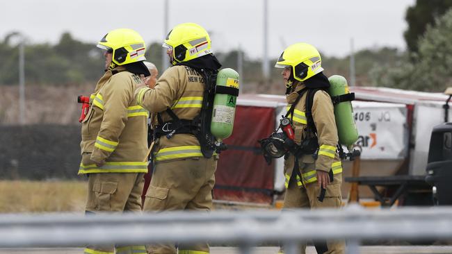 Four fire crews were called onto the tarmac at Newcastle Airport to assess the plane. Picture: Peter Lorimer