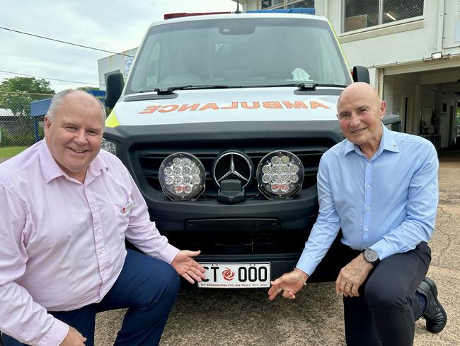St John NT chief executive Andrew Tombs and Administrator of the Northern Territory Hugh Heggie with ambulance #74 and a Cyclone Tracy commemorative number plate. Picture: Sam Lowe
