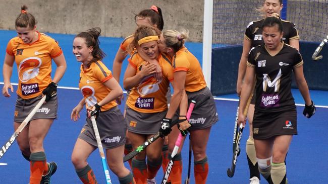 Britt Wilkinson of the Brisbane Blaze is congratulated by her teammates after scoring. (AAP Image/Scott Barbour)