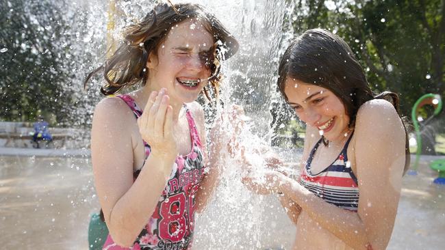 Hannah Collins (left) and Zoe Davis having fun under the water bucket at the Wisemans Ferry water park. Picture: David Swift