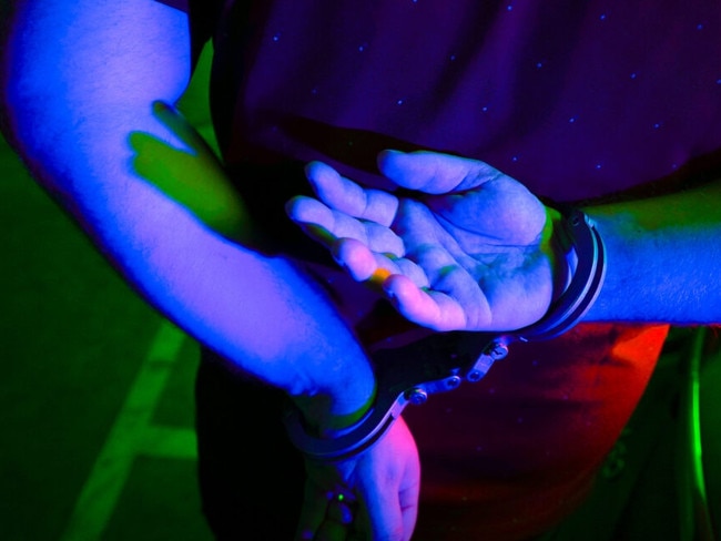 Cairns police generic handcuffs night