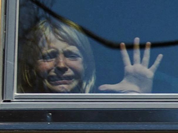 A child weeps while on the bus leaving The Covenant School, following a mass shooting at the school in Nashville, Tennessee, U.S. March 27, 2023.  Nicole Hester/USA Today Network via REUTERS