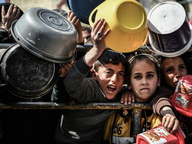 Muhammad, 11, and Reham, 9, stand at a food distribution centres in Rafah, south of the Gaza Strip. Picture: UNICEF