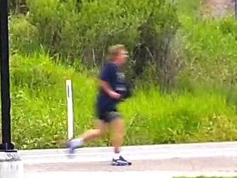 A still from CCTV footage showing Neil Bennett running near the Sheep Station Creek Bridge at Morayfield on January 11.
