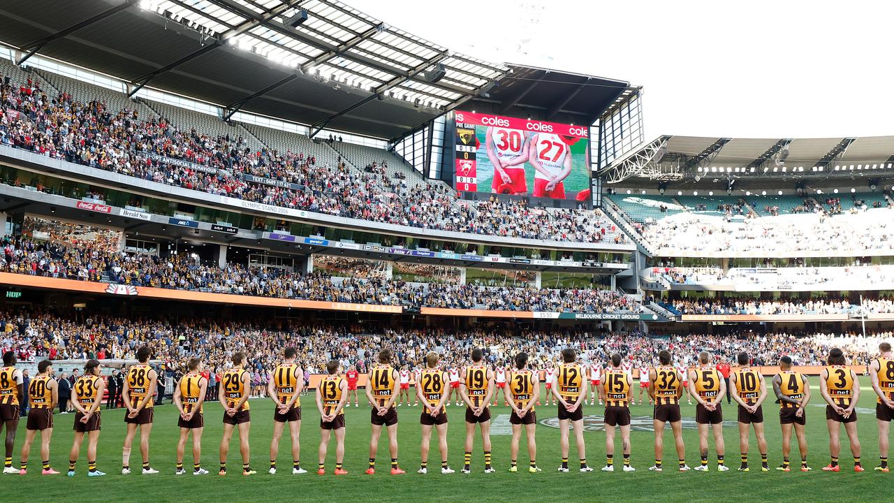MELBOURNE, AUSTRALIA - APRIL 28: The Hawks pause for the Last Post during the 2024 AFL Round 07 match between the Hawthorn Hawks and the Sydney Swans at the Melbourne Cricket Ground on April 28, 2024 in Melbourne, Australia. (Photo by Michael Willson/AFL Photos via Getty Images)