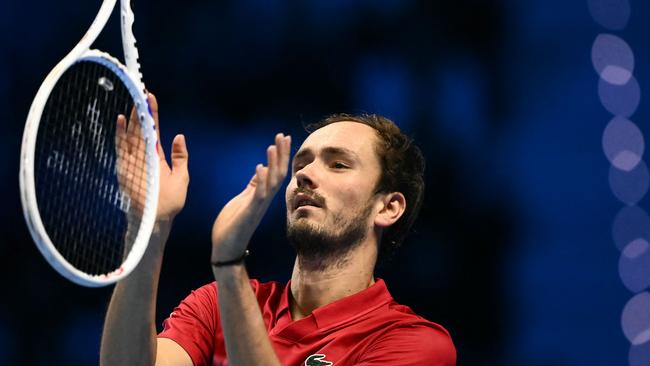 Daniil Medvedev pretended to attempt to catch his racket. (Photo by Marco BERTORELLO / AFP)