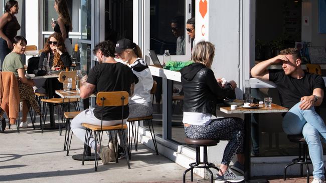 Customers sitting outside a cafe, which have been gradually reopening in the last several days. Picture: AAP Image/James Gourley