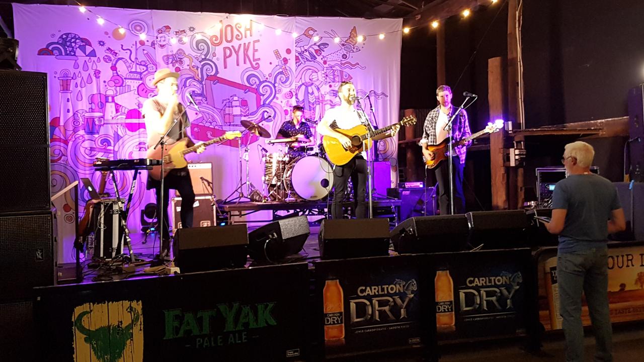 Legendary Toowoomba sound engineer Howard Brooks, pictured here doing a soundcheck for Josh Pyke, has died aged 54.