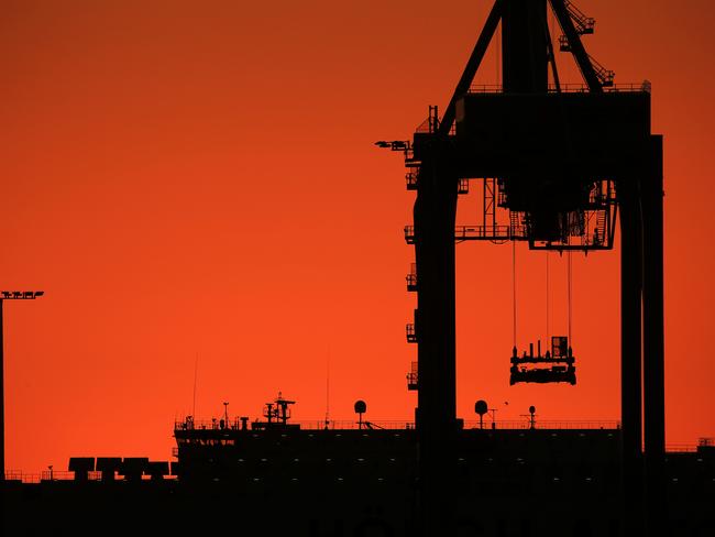 The sun sets over the Port Melbourne docks before temperatures are set to rise over 40 degrees in coming days. Picture: Mark Stewart