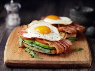 Home made freshness bacon,fried egg with avocado ,tomato and rocket leaves on fried soda bread