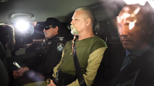 Troy James O’Meara is driven by police to the Police Watch House in Brisbane, Wednesday, August 22, 2018 after being arrested for the 1983 murder of Linda Reed on the Gold Coast. (AAP Image/Dave Hunt)