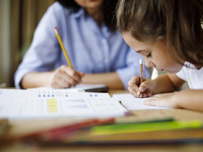 Mother helping daughter with homework