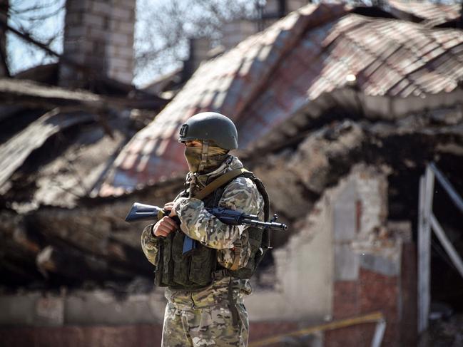 A Russian soldier stands in front of an apartment building in the self-proclaimed Donetsk People's Republic. Russian separatist forces say that have taken the port city of Mariupol. Picture: AFP