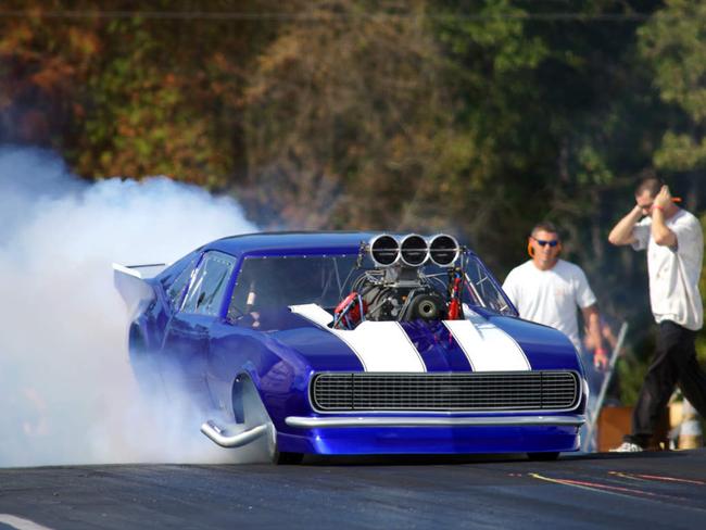 race car reving it up and burning rubber at the dragstrip
