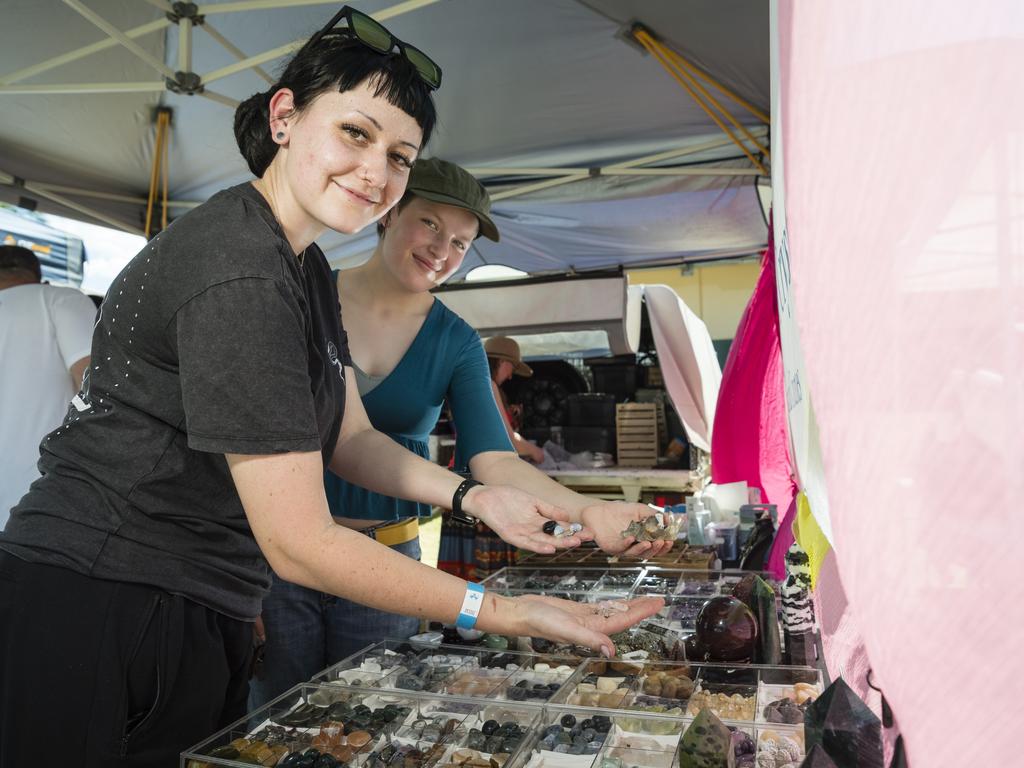 Crystal lovers Kelsey Hagger (left) and Chelsea Moore look for treasures at the Time Keeper Crystals stall at Gemfest hosted by Toowoomba Lapidary Club at Centenary Heights State High School, Saturday, October 21, 2023. Picture: Kevin Farmer