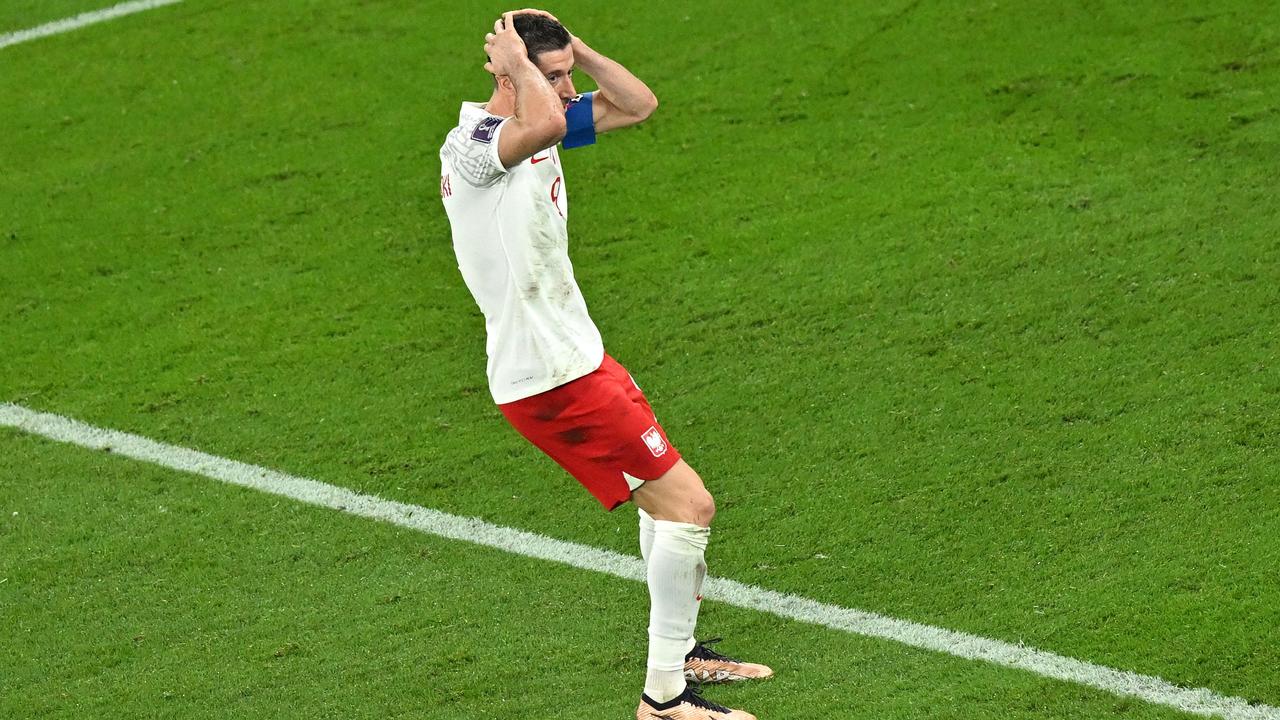 Robert Lewandowski reacts after Mexico's goalkeeper Guillermo Ochoa stopped his penalty kick. (Photo by Glyn KIRK / AFP)