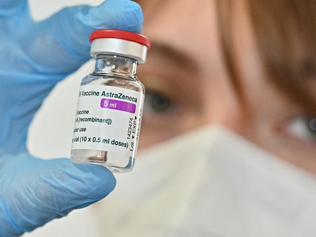 (FILES) In this file photo taken on March 24, 2021 a medical worker holds a vial of the AstraZeneca vaccine against Covid-19 at a vaccination hub outside Rome's Termini railway station, as the vaccination campaing continues despite delays across the country . - The EU executive is suing British-Swedish pharmaceutical group AstraZeneca to force it to deliver 90 million more doses of its Covid-19 vaccine before July, a spokesman said on May 11, 2021. "We want the court to order the company to deliver 90 million additional doses, in addition to the 30 million already delivered in the first quarter," spokesman Stefan De Keersmaecker told a media conference. (Photo by ANDREAS SOLARO / AFP)