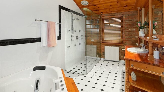 The central bathroom with a corner spa bath and separate double shower.