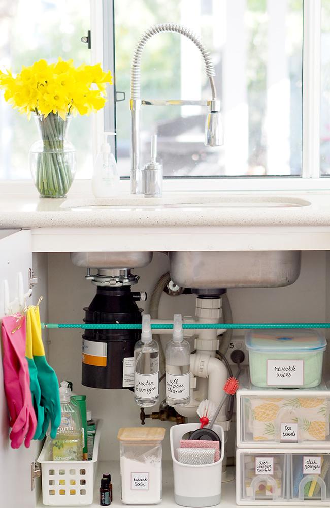 Kat’s kitchen sink cupboard maximises space with the use of a $2.80 rod from Daiso.