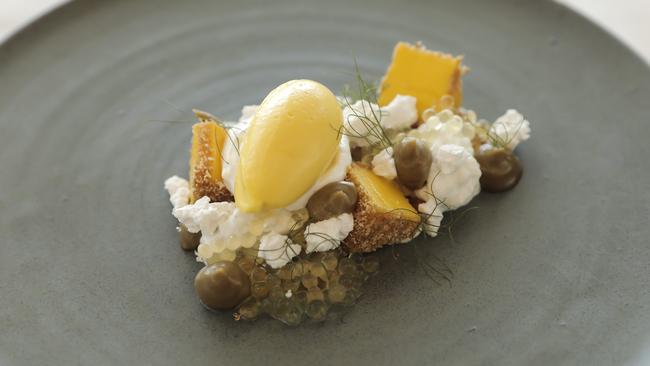 A lovely coconut and mango pudding with yuzu and liquorice flavours. Picture: Mark Cranitch.