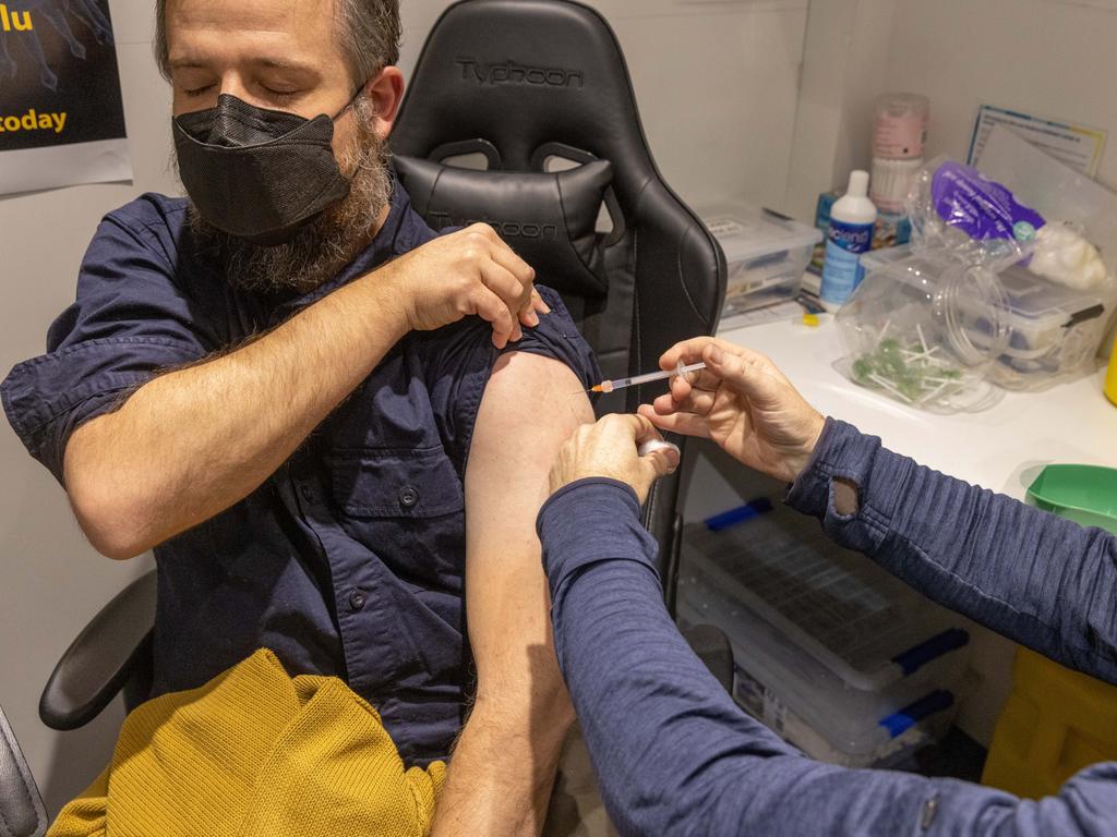 A pharmacist administers a Covid-19 vaccination booster shot to a customer at Exhibition Pharmacy in Melbourne, Australia. Picture: Asanka Ratnayake/Getty Images