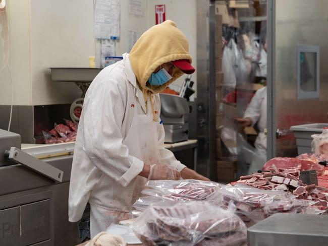 NEW YORK, NY - APRIL 17: A butcher processes some meat at Vincents Meat Market on April 17, 2020, in Bronx borough of New York City. Some of the country's largest meat processing plants closed due to the COVID-19 outbreak after a factory in South Dakota was closed after nearly 300 of its 3,700 employees tested positive.   David Dee Delgado/Getty Images/AFP == FOR NEWSPAPERS, INTERNET, TELCOS & TELEVISION USE ONLY ==