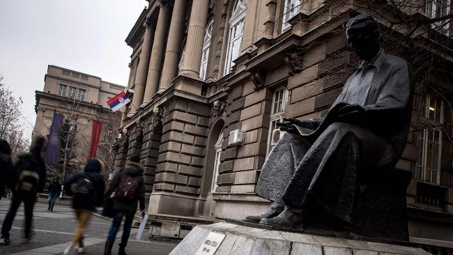 Students walks past a statue of Serbian-American scientist NikolaTesla in front the technical faculties building in Belgrade.