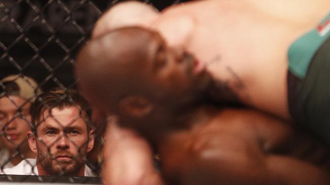 Chris Hemsworth looks on as Lando Vannata and Marcos Mariano do battle. Picture: AAP Image/Daniel Pockett