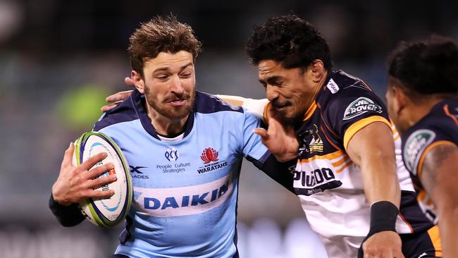 James Ramm of the Waratahs is tackled by Pete Samu of the Brumbies. Picture: Getty Images