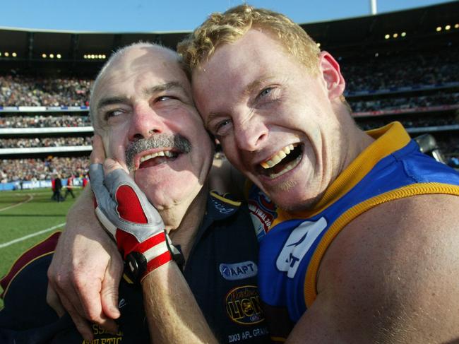 Leigh Matthews and Michael Voss celebrate after the 2003 premiership. Picture: David Kapernick