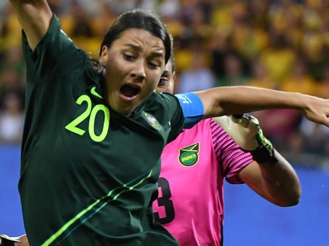 Australia's forward Samantha Kerr (L) vies for the ball with Jamaica's goalkeeper Nicole McClure during the France 2019 Women's World Cup Group C football match between Jamaica and Australia, on June 18, 2019, at the Alpes Stadium Grenoble, central-eastern France. (Photo by Jean-Pierre Clatot / AFP)