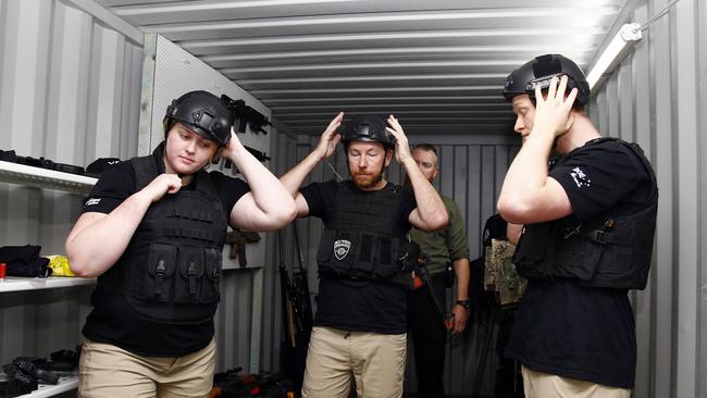 Christina Fern, Adam Kirk and Nathan Walt putting on riot gear. Picture: Tertius Pickard