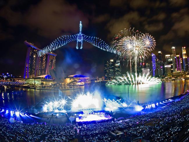 Drones are seen in the sky forming the shape of a crane as Singapore awaits 2020 with curtain-raiser fireworks by Star Island. Picture: Getty