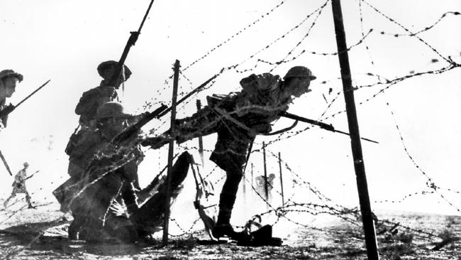 Australian soldiers charge through barbed wire at Battle of El Alamein during World War Two. Picture: Australian War Memorial