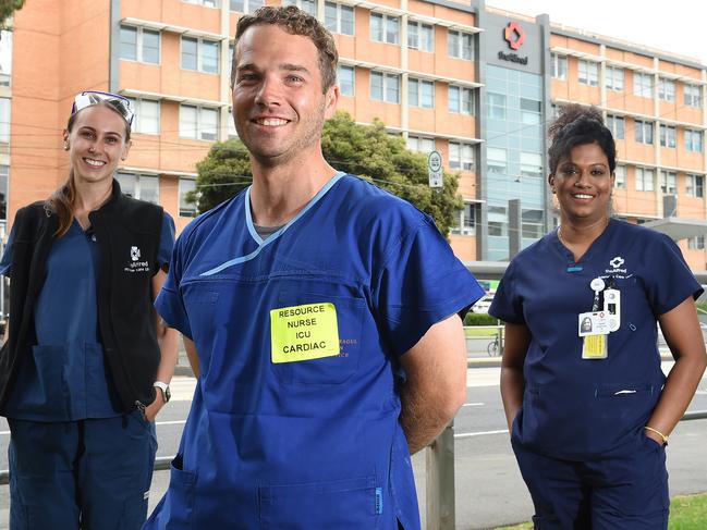 Hospital workers in front of The Alfred Hospital celebrating the end of a horror 2020 and looking forward to a better 2021. (L-R) ICU nurses Bianca Rose, Sebastian Hands and Smitha Sivaprasad. Picture: Josie Hayden