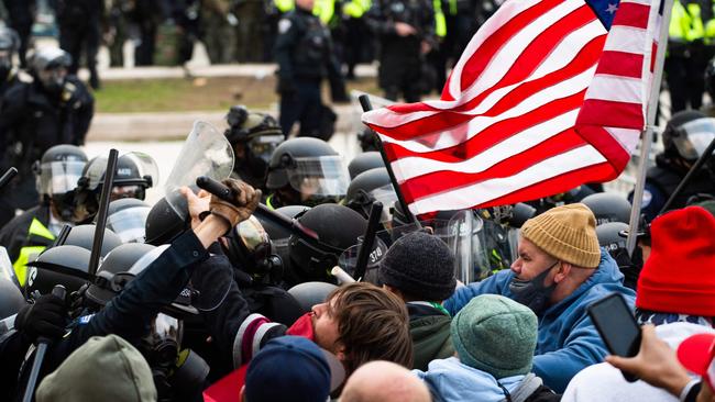 Supporters of US President Donald Trump fight with riot police outside the Capitol building on January 6, 2021.