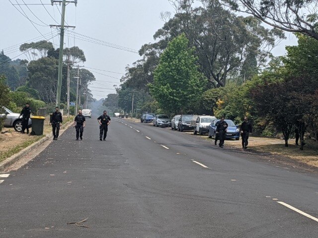 Officers search for clues at the crime scene.